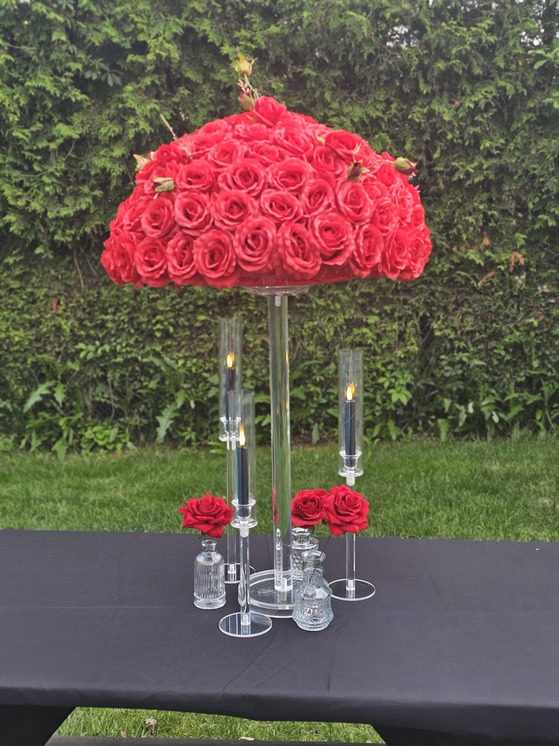 Red floral centrepieces with aryclic stand