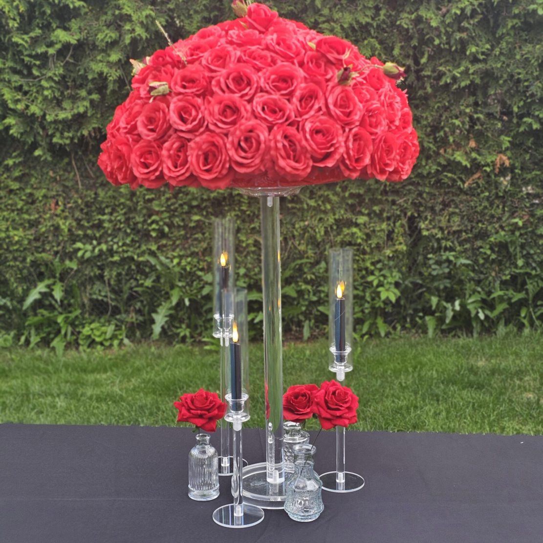 Red floral centrepieces with aryclic stand